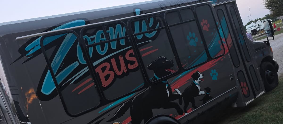 The Zoomie Bus wrap, painted with running dogs