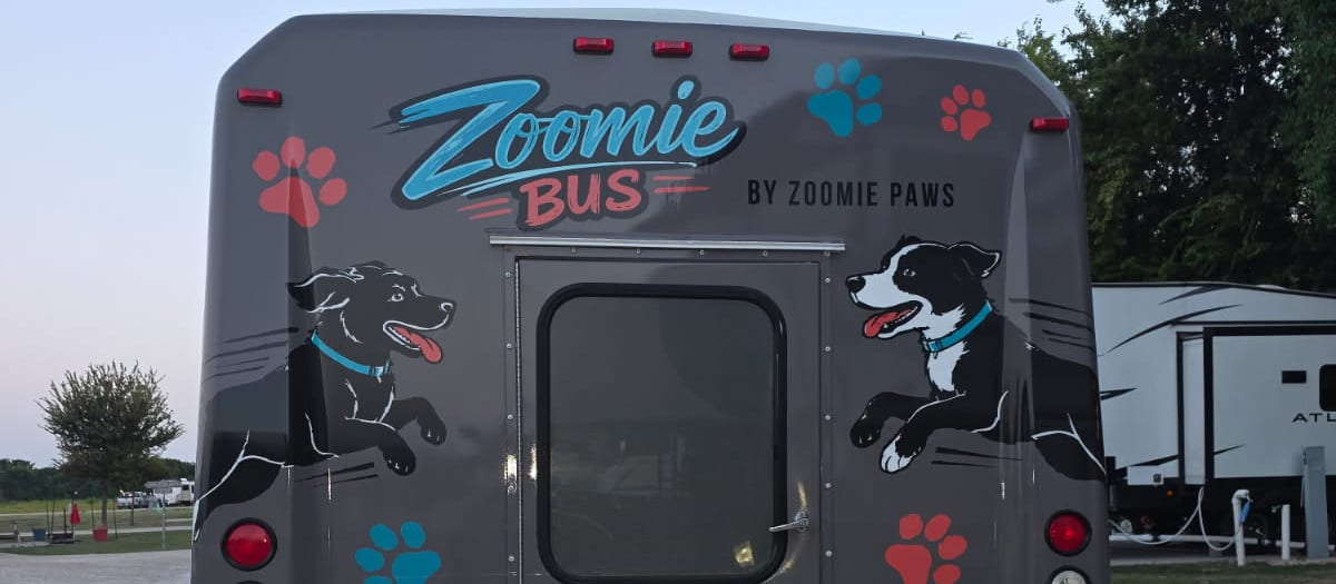 The Zoomie Bus parked under open Texoma sky